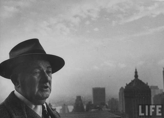 "William McCormack stands before skyline his concrete helped build including, Chrysler and New York Central UN buildings." December 1952